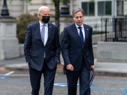 President Joe Biden walks with Secretary of State Antony Blinken across West Executive Ave