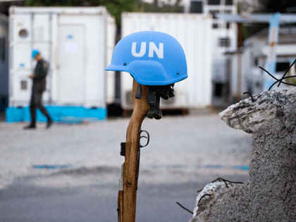 This Feb. 22, 2017 photo shows a U.N. peacekeeper's blue helmet balanced on a weapon in Po