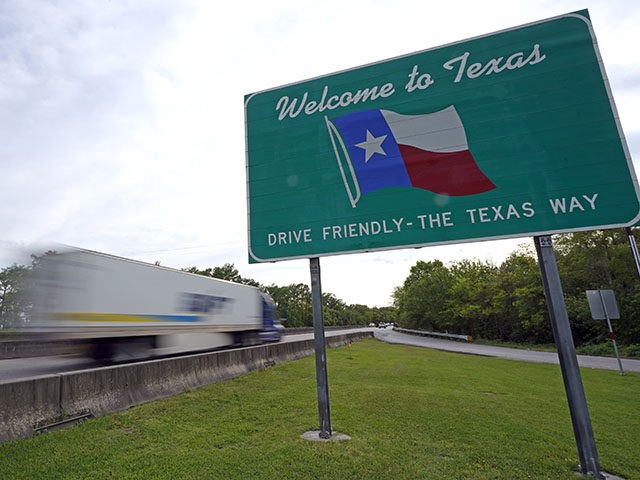 A truck passes a welcome sign along I-10 Sunday, March 29, 2020, in Orange, Texas, near the Louisiana border. Texas is ratcheting up restrictions on neighboring Louisiana, one of the growing hot spots for coronavirus in the U.S. Just two days after Texas began requiring airline passengers from New Orleans …