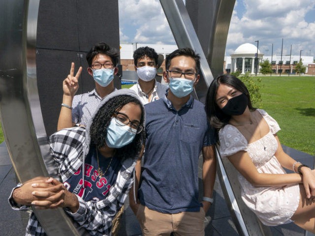 Rising seniors at the Thomas Jefferson High School for Science and Technology gather on the campus in Alexandria, Va., Monday, Aug. 10, 2020. From left in front are, Dinan Elsyad, 17, Sean Nguyen, 16, and Tiffany Ji, 17. From left at rear are, Jordan Lee, 17, and Shibli Nomani, 17. …