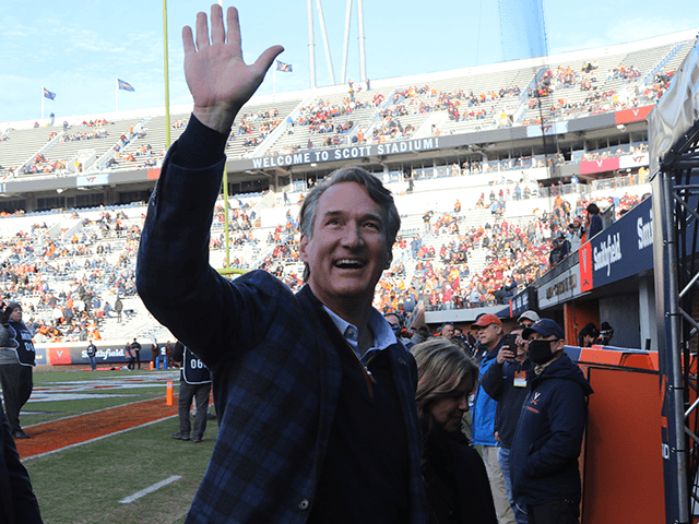 Virginia Gov.-elect, Glenn Youngkin waves to the crowd prior to the start of an NCAA colle