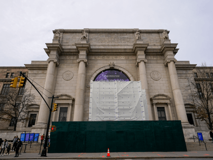 A wall, scaffolding and white tarp surround what is left of the controversial equestrian statue of President Theodore Roosevelt, at the American Museum of Natural History, Wednesday, Jan. 19, 2022, in New York. A crew removed a portion of the statue overnight. (AP Photo/Mary Altaffer)