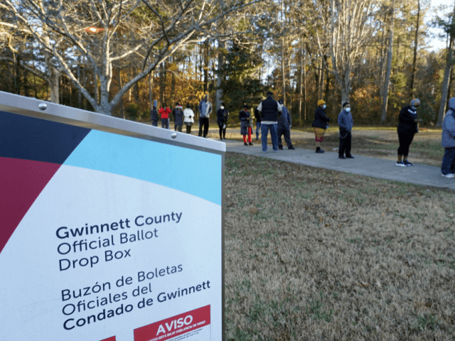 Voters stand in line to cast their ballots during the first day of early voting in the US Senate runoffs at Lenora Park, December 14, 2020, in Atlanta, Georgia. - Six weeks after the contentious US presidential election, early in-person voting began Monday in Georgia ahead of a new fateful …