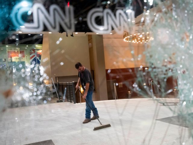 A worker cleans the lobby of CNN after rioting and protests in Atlanta on May 29, 2020. - The death of George Floyd on May 25 while under police custody has sparked violent demonstrations across the US. (Photo by John Amis / AFP) (Photo by JOHN AMIS/AFP via Getty Images)