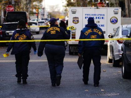 Members of the Crime Scene Unit walk near the location of a shooting in Philadelphia, Wedn