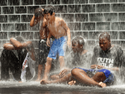 CHICAGO - JUNE 24: Kids play in the water at Crown Fountain in Millennium Park June 24, 2005 in Chicago, Illinois. With near-record high temperatures predicted in the Chicago area for today, children and adults sought relief from the ninety-plus temperatures any way they could. (Photo by Tim Boyle/Getty Images)