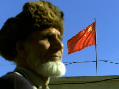 A brand new flag of the Republic of China is flown on top of the Chinese embassy after it was replaced with the old one in Kabul, 20 December 2001, while its security guard Aziz Ullah appears in the foreground. A Chinese delegation headed by former ambassador Zhang Min arrived …