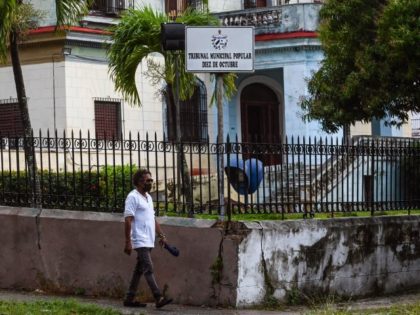 A man walks in front of the building of the 10 de Octubre Popular Municipal Court, where several detainees were charged with sedition for anti-government protests on July 11 and 12, 2021, in Havana, on January 12, 2022. - Cuba is imposing sentences of up to 30 years to demonstrators …