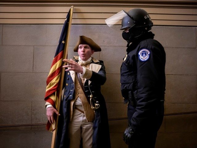 WASHINGTON, DC - JANUARY 6: A protester dressed as George Washington debates with a Capitol Police before being pushed out. Supporters of US President Donald Trump protested inside the US Capitol on January 6, 2021, in Washington, DC. - Demonstrators breeched security and entered the Capitol as Congress debated the …