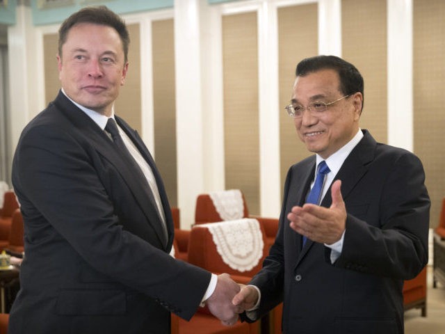 BEIJING, CHINA - JANUARY 09: Tesla CEO Elon Musk, left, shakes hands with Chinese Premier