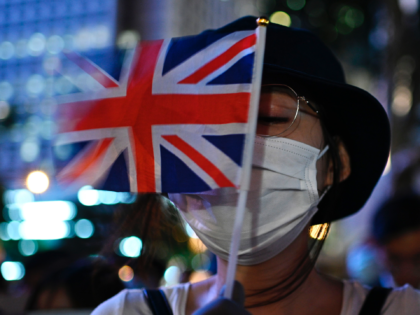 A protester holds the British Union Jack flag as she attends the Stand in Silence for the