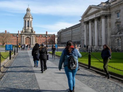 People walk around the grounds of Trinity College Dublin on March 12, 2020. - Ireland on Thursday announced the closure of all schools and colleges, and recommended the cancellation of mass gatherings as part of measures to combat the spread of the coronavirus. Prime Minister Leo Varadkar said "schools, colleges …