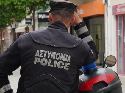Cypriot policemen issue a fine to a man along the Ledra main street in the old walled city of the capital Nicosia on May 4, 2020, for not abiding according to the movement rules set during the COVID-19 coronavirus pandemic lockdown requiring authorisation by text message before leaving the place …