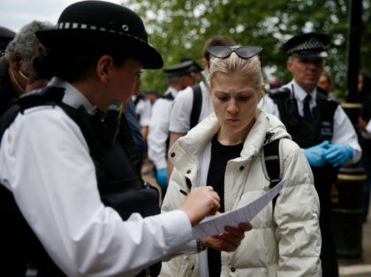 LONDON, ENGLAND - MAY 16: A police officer fines a protester as people demonstrate against the coronavirus lockdown in Hyde Park on May 16, 2020 in London, United Kingdom. The prime minister announced the general contours of a phased exit from the current lockdown, adopted nearly two months ago in …