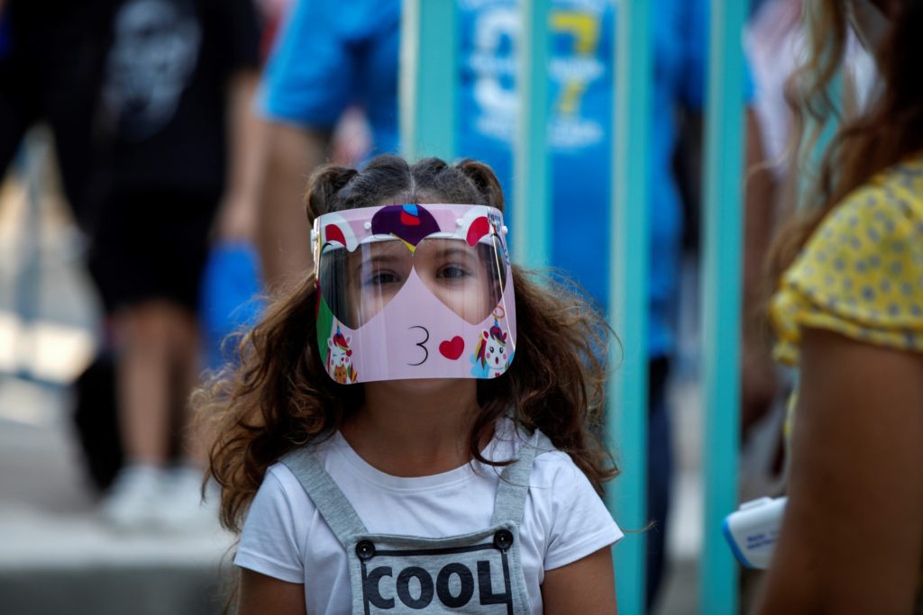 A pupil wearing a face mask arrives at a primary school on the first day of class of the new academic year in Athens, on September 14, 2020, amid the crisis linked with the covid-19 pandemic caused by the novel coronavirus. - Schools open on Monday amid concerns due to a new spike in coronavirus infections and along with resistance by some parents to a regulation stipulating that all children and adults must wear protective face masks. (Photo by Thanassis Stavrakis / POOL / AFP) (Photo by THANASSIS STAVRAKIS/POOL/AFP via Getty Images)