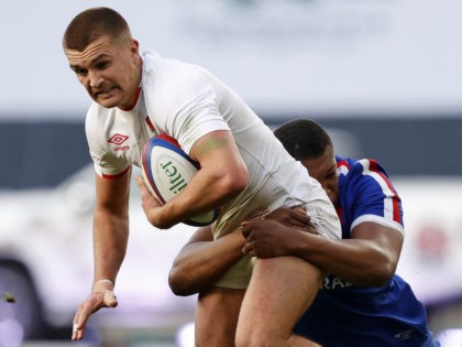 England's centre Henry Slade is tackled by France's flanker Cameron Woki during the final
