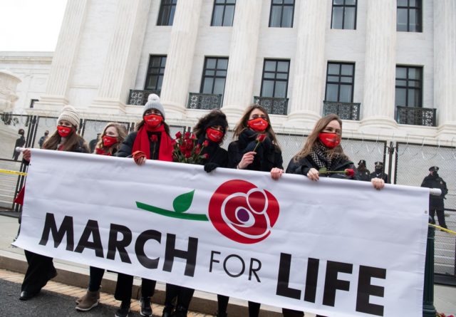Anti-abortion activists participate in the "March for Life," an annual event to mark the anniversary of the 1973 Supreme Court case Roe v. Wade, which legalized abortion in the US, outside the US Supreme Court in Washington, DC, January 29, 2021.