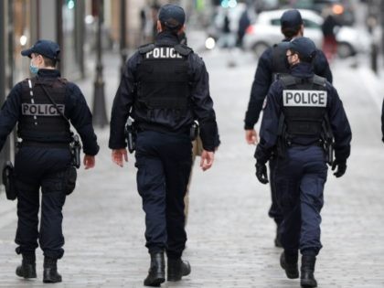 Police officers patrol near Le Printemps shopping centre in Paris on January 31, 2021, as big shopping centres are closed as a measure taken to curb the spread of the Covid-19. - France closed its borders to all non-EU travellers except those on essential trips, and closed big shopping centres …