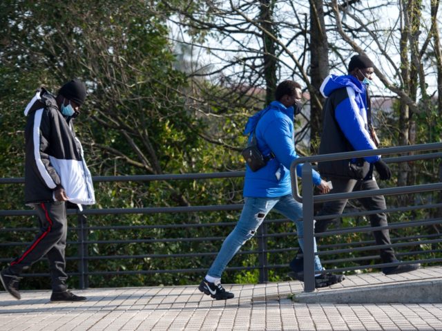Migrants walks near the closed bridge at the border crossing point between Irun and Hendaye, on March 10, 2021. - Migrants wait in the Spanish Basque city of Irun for a chance to cross the border into France on their way to Northen Europe. (Photo by ANDER GILLENEA / AFP) …