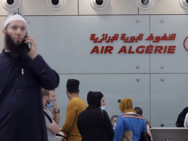 Passengers wait to check in at an Air Algeria counter for a flight to Paris at Algiers' Houari Boumediene Airport on June 1, 2021, after Algeria reopened its borders following a 15-months closure due to the Covid-19 pandemic. - Algeria has slightly relaxed the conditions for entry to its soil …