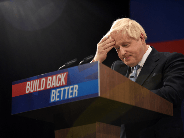 Britain's Prime Minister Boris Johnson gestures as he delivers his keynote speech on the final day of the annual Conservative Party Conference at the Manchester Central convention centre in Manchester, northwest England, on October 6, 2021. (Photo by Oli SCARFF / AFP) (Photo by OLI SCARFF/AFP via Getty Images)