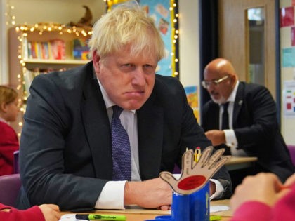 RISTOL, ENGLAND - OCTOBER 15: UK Prime Minister Boris Johnson meets with school children during a visit to Westbury-On-Trym Church of England Academy, prior to a regional cabinet meeting in the city later, on October 15, 2021 in Bristol, England. (Photo Steve Parsons - WPA Pool/Getty Images)