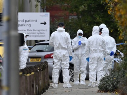 Police forensics officers at an entrance to the Women's Hospital in Liverpool on November 15, 2021, following yesterday's taxi explosion. - Police in northwest England on Monday said they were treating a deadly blast outside a hospital in Liverpool as a "terrorist incident" involving a homemade bomb that was reportedly …