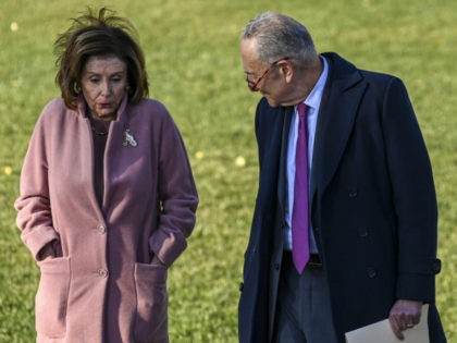 WASHINGTON, DC - NOVEMBER 15: U.S. House Speaker Nancy Pelosi (D-CA) and Senate Majority Leader Charles Schumer (D-NY) talk at the signing ceremony for the Infrastructure Investment and Jobs Act at the White House November 15, 2021 in Washington, DC. The $1.2 trillion package will provide funds for public infrastructure …