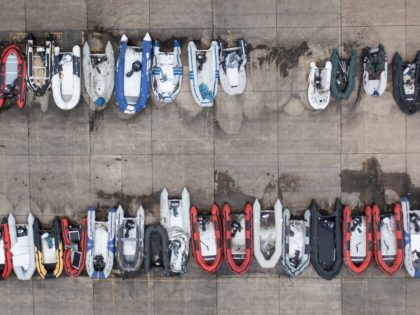 TOPSHOT - An aerial view shows dinghies stored in a Port Authority yard, believed to have been used by migrants picked up at sea whilst crossing the English Channel, in Dover, southeast England, on December 21, 2021. - Migrants who crossed the Channel to Britain from northern France are being …