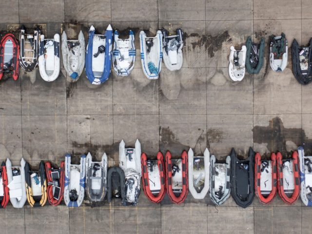 TOPSHOT - An aerial view shows dinghies stored in a Port Authority yard, believed to have