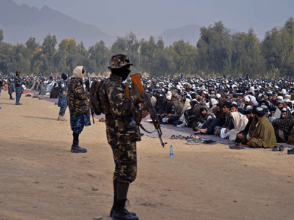 Taliban fighters stand guard as Afghans prepare to offer special prayers for rains at Eidgah in Kandahar on December 25, 2021. (Photo by Javed TANVEER / AFP) (Photo by JAVED TANVEER/AFP via Getty Images)