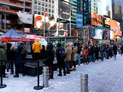 People line up for Covid-19 testing in Times Square on January 4, 2022, in New York City. - The US recorded more than 1 million Covid-19 cases on January 3, 2022, according to data from Johns Hopkins University, as the Omicron variant continues to spread at a blistering pace. Johns …