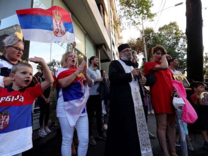 A Serbian orthodox priest (3rd R) gestures as supporters of Serbia's Novak Djokovic gather during a prayer outside a government detention centre where the tennis champion is reported to be staying in Melbourne on January 7, 2022, after Australia said it had cancelled the entry visa of Djokovic, opening the …