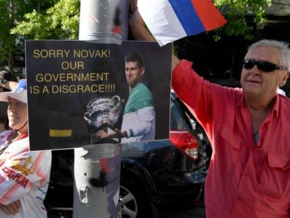 TOPSHOT - Members of the local Serbian community rally outside a government detention centre where Serbia's tennis champion Novak Djokovic is staying in Melbourne on January 9, 2022, with Djokovic set for his day in court on Monday 10 to challenge the shock cancellation of his visa over Covid rules, …