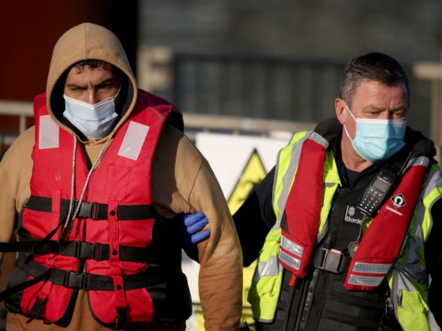 DOVER, ENGLAND - JANUARY 17: A migrant (L) arrives at the Port of Dover after being intercepted in the channel by the UK Border Force on January 17, 2022 in Dungeness, England. Over 28,000 migrants crossed the English Channel by boat last year, three times as many as in 2020, …