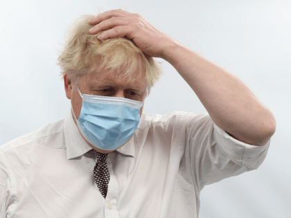 British Prime Minister Boris Johnson gestures as he visits Finchley Memorial Hospital in North London on January 18, 2022. - Johnson "categorically" rejected claims by his former chief aide that he lied to parliament last week about a Downing Street party held during a strict lockdown. (Photo by Ian Vogler …