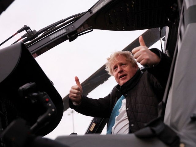 HOLYHEAD, UNITED KINGDOM - JANUARY 27: Prime Minister Boris Johnson gestures as he visits RAF Valley in Holyhead on January 27, 2022 in Anglesey, North Wales. The findings from Sue Gray's inquiry into several alleged lockdown rule-breaking parties at Downing Street, during the time when strict Covid-19 restrictions were in …