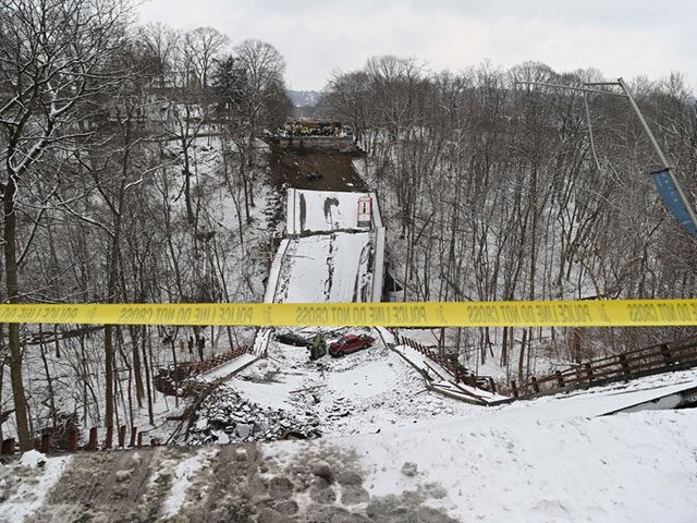 US President Joe Biden visits the scene of the Forbes Avenue Bridge collapse over Fern Hollow Creek in Frick Park in Pittsburgh, Pennsylvania, January 28, 2022. - The bridge collapse provided a symbolic backdrop for President Biden's trip to the city to tout his $1 trillion infrastructure plan -- and …