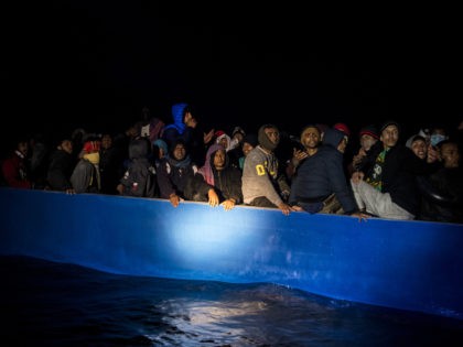 AT SEA - MARCH 29: The focus of a rescue boat from the NGO Open Arms focuses on a wooden boat with approximately 100 migrants of various nationalities heading to Lampedusa through the Mediterranean on March 29, 2021 in At Sea, Unspecified. The Spanish NGO Open Arms rescued passengers in …