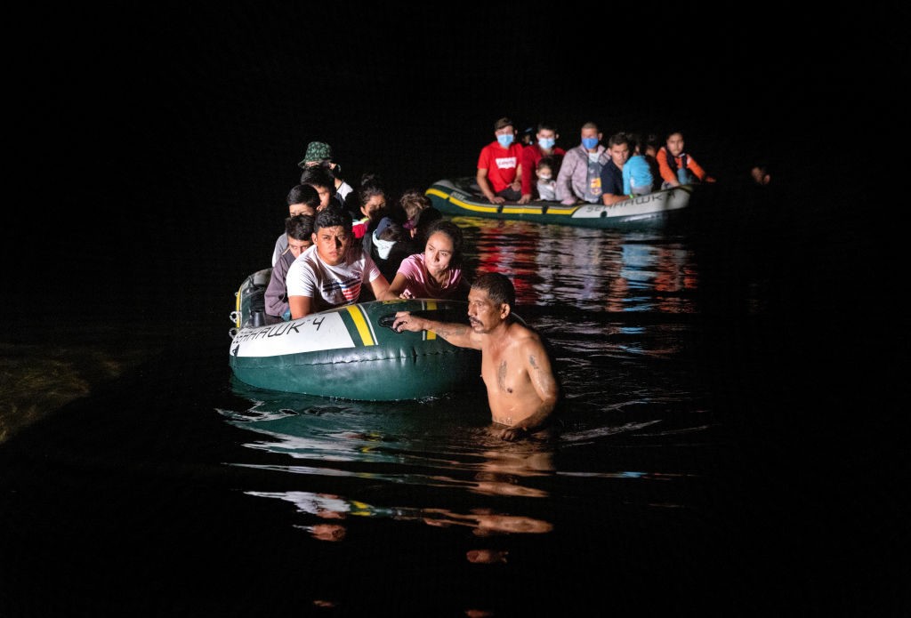 ROMA, TEXAS - AUGUST 13: Smugglers guide groups of immigrants across the Rio Grande while crossing the border from Mexico on August 13, 2021 in Roma, Texas. Recent U.S. Customs and Border Protection figures show more than 200,000 people were apprehended at the border in July, the highest number in 21 years. More than 82,000 of those were family members traveling together. (Photo by John Moore/Getty Images)(Photo by John Moore/Getty Images)