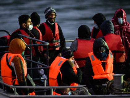 DOVER, ENGLAND - DECEMBER 16: A group of men wait to disembark from a coastguard vessel on December 16, 2021 in Dover, England. A report published today found that migrants who arrived in Kent after crossing the English Channel were being held in poor conditions at migrant detention centres, according …