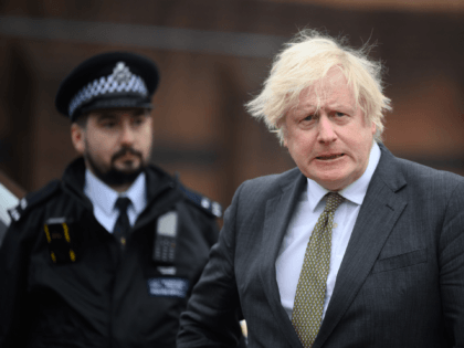 UXBRIDGE, ENGLAND - DECEMBER 17: Britain's Prime Minster Boris Johnson speaks with police officers as he makes a constituency visit to Uxbridge police station on December 17, 2021 in Uxbridge, England. (Photo by Leon Neal/Getty Images)