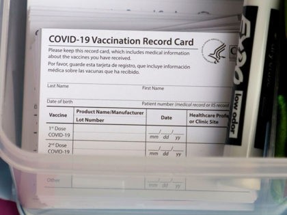 LAS VEGAS, NEVADA - DECEMBER 21: Blank COVID-19 vaccination cards are stacked at a pop-up COVID-19 vaccination clinic at Larry Flynt's Hustler Club on December 21, 2021 in Las Vegas, Nevada. With the Omicron variant on the rise, the club partnered with Immunize Nevada to launch "Boobs for Boosters," its …