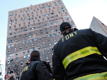 Firefighters gather in front of a Bronx apartment building a day after a fire swept through the complex killing at least 19 people and injuring dozens of others, many of them seriously on January 10, 2022 in New York City. The five-alarm NYC fire began around 11 am Sunday when …