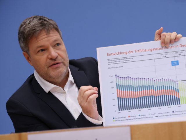 BERLIN, GERMANY - JANUARY 11: Economy and Climate Minister Robert Habeck holds up a graph showing Germany's past and projected greenhouse gas emissions as he outlined the federal government's accelerated plan for reaching national climate goals on January 11, 2022 in Berlin, Germany. The new federal coalition government of Social …