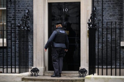 LONDON, ENGLAND - JANUARY 11: A police officer knocks on the door of number 10, Downing S