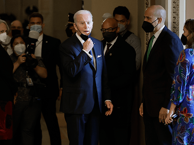 President Joe Biden pulls down his mask to answer a reporter's question after paying respects to former Senate Majority Leader Harry Reid as he lies in state in the U.S. Capitol on January 12, 2022 in Washington, DC. A Democrat, Reid represented Nevada in Congress for more than 30 years, …