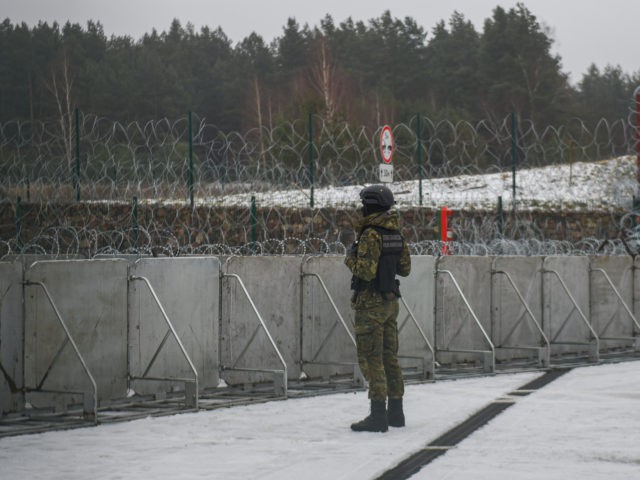 KUZNICA, POLAND - JANUARY 13: A border guard officer stands guard next to a blockade at th