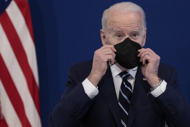 U.S. President Joe Biden holds a mask as he gives remarks on his administration's response to the surge in COVID-19 cases across the country from the South Court Auditorium in the Eisenhower Executive Office Building on January 13, 2022 in Washington, DC. During the remarks President Biden urged unvaccinated individuals …