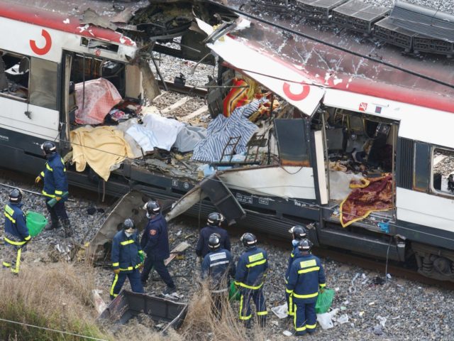MADRID, SPAIN - MARCH 11: Rescue workers search through the wreckage of a commuter train March 11, 2004 after it was devastated by a bomb blast during the morning rush hour in Madrid, Spain. According to Madrid officials at least 182 people were killed in the series of three blasts. …